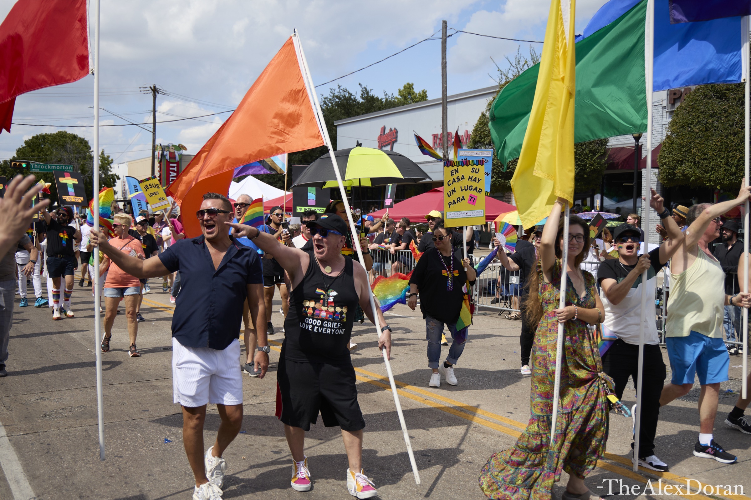 Pride in Dallas parade on Cedar Springs Road with rainbow flags